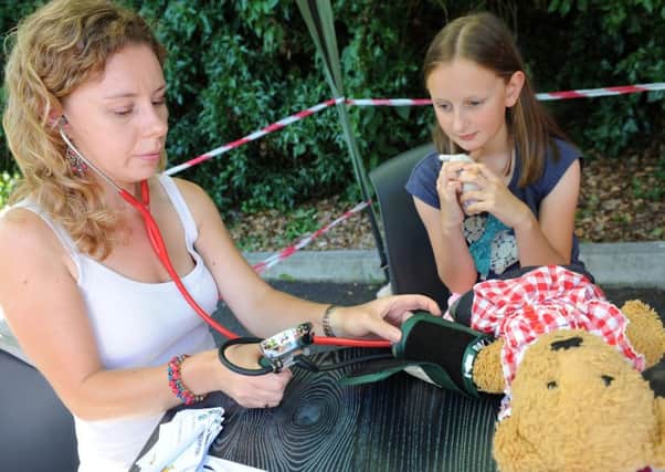 Alice from Worthing has her teddy checked by Dr Roz at the Emergency Services Day