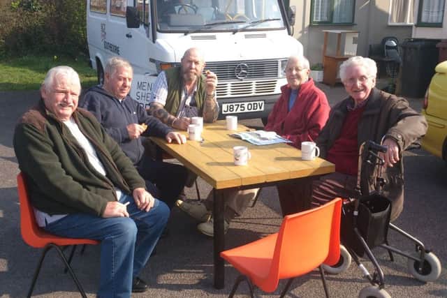 Coffee and chat around the table that shedders repaired