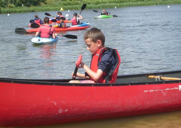 Trying out canoeing at Scout camp