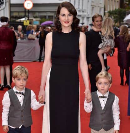 Zac Barker (left) and Oliver Barker from Ashington who play the role of Master George Crawley in Downton Abbey are pictured at the special BAFTA red carpet event for the show with actress Michelle Dockery who plays their on-screen mum. Picture courtesy of RayTang/Rex Shutterstock. SUS-151208-102040001
