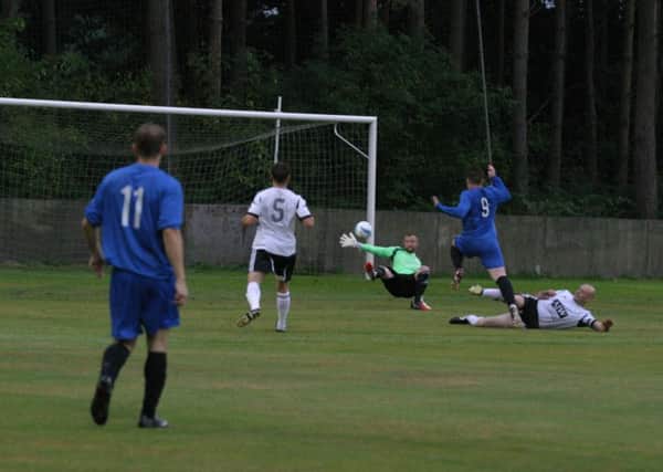 Sam Schaaf opens up for Horsham YMCA`s first goal against Loxwood. Photo by Clive Turner