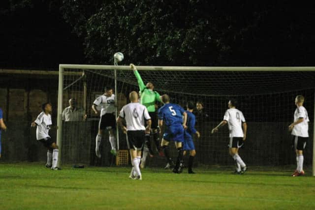 Loxwood goalkeeper Chris Coles makes safe from YM attack. Photo by Clive Turner.