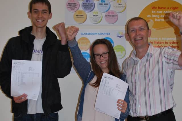 High achievers Ed Steins (AAB) and Holly Capper (A*A*A) with principal Mick Garlick