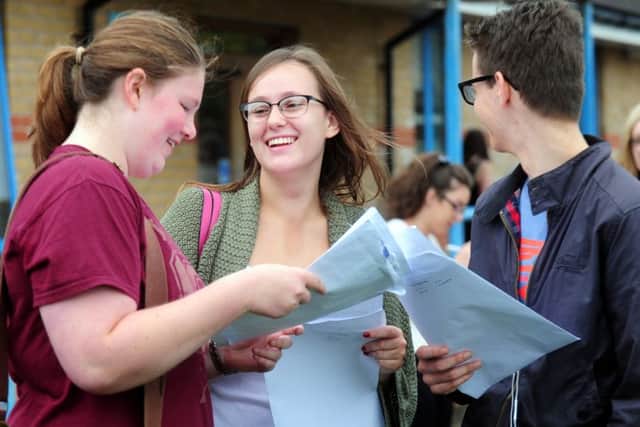 Sophie Griffiths, 18, Katy Doolan, 18 and Adam Groussin, 18, discussing their grades.ks1500368-2 SUS-150813-145218008