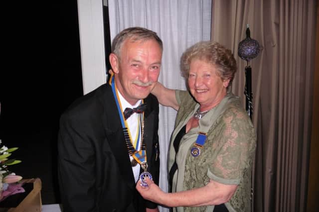 Rotary Club of Senlac President, Roger Young, is welcomed into his new post by outgoing President, Christine Folley. SUS-150820-121313001