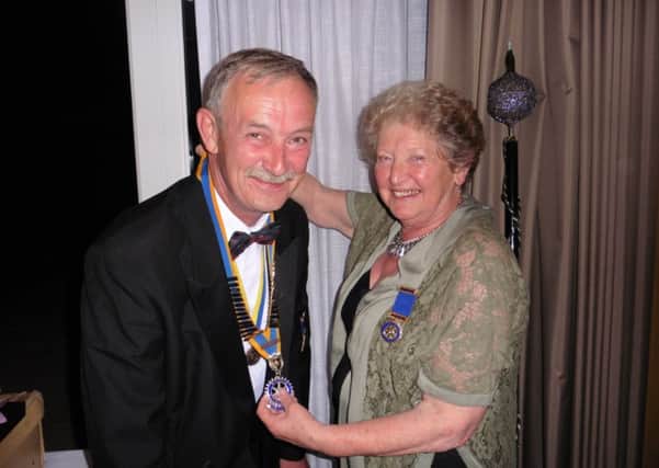 Rotary Club of Senlac President, Roger Young, is welcomed into his new post by outgoing President, Christine Folley. SUS-150820-133535001