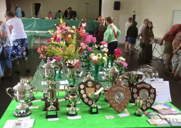Cups and shields were presented to the annual flower and vegetable show winners