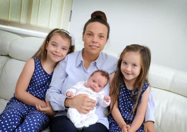 Natalie Eldridge pictured with baby Betsy, Winchelsea Beach. L-R Tilly, Natalie, Betsy and Dolly. SUS-150818-114843001