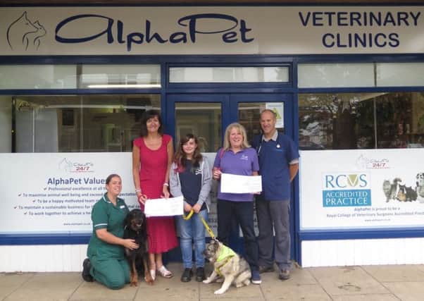 Naomi from Many Tears and Jane from Canine Partners receiving their cheques from lead medical nurse Charlie Sampson and director Paul Irvine-Smith. Picture: Richard Edwards (director)