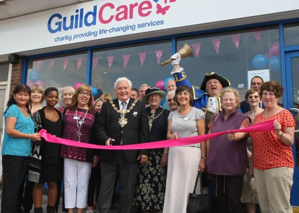 Worthing mayor Michael Donin cuts the ribbon to open the new Guild Care charity shop DM155742a