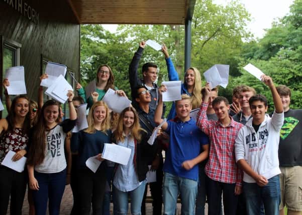 Claremont Senior School students hold their fantastic GSCE results aloft