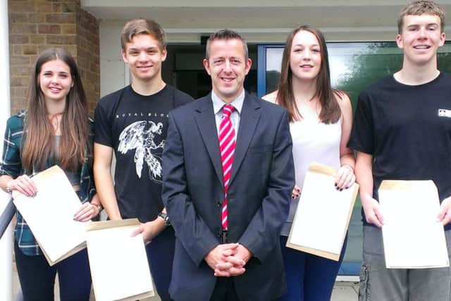 Bourne Commnunity College headteacher Simon Liley celebrates fantastic GCSE results with pupils (from left) Lori Byrne, Reuben James, Issy Gilbert and Sam Tweedle SUS-150820-131614001