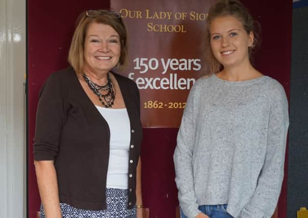 Ann Whitchurch, director of studies, with year-11 students Matilda Fuller, right, as she collects her results