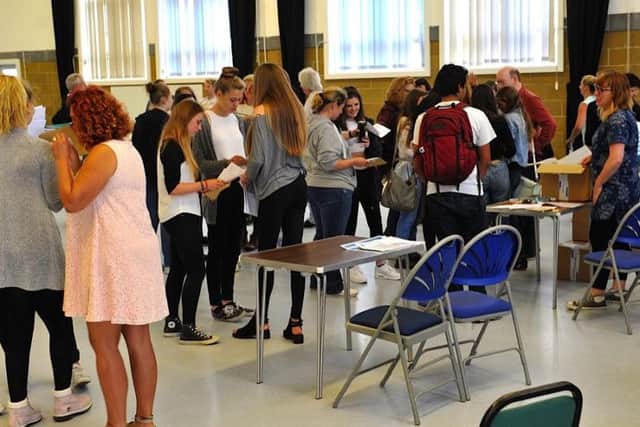 Teenagers packed into the school's hall to collect their GCSEs    PHOTO: Stephen Goodger  SGTAS1