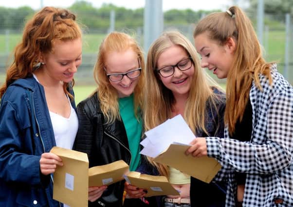 Luciie Parker, 16, Charlotte Bichard, 16, Melissa Taylor, 16, and Sophie Young,  16, looking  at their results
