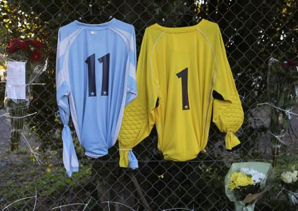 Two shirts and floral tributes outside Worthing United Football Club. Worthing United footballers Matthew Grimstone, 23, and Jacob Schilt were on their way to play in a match against Loxwood FC when they were caught up in the Shoreham air crash. PRESS ASSOCIATION Photo. Picture date: Sunday August 23, 2015. Seven people died when an historic Hawker Hunter fighter jet plummeted on to the A27 at Shoreham in West Sussex after failing to pull out of a loop manoeuvre. See PA story AIR Crash. Photo credit should read: Daniel Leal-Olivas/PA Wire AIR_Crash_194942.JPG