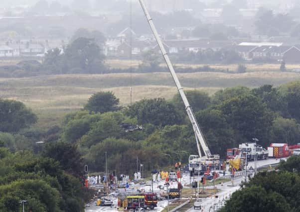 A crane removes wreckage from the scene.
General view emergency workers at  the scene of the Shoreham airshow crash two days after the incident. SUS-150824-143454001