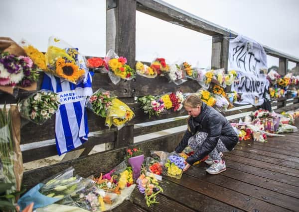 Floral tributes to the victims of the Shoreham Airshow crash placed on the Shoreham Tollbridge