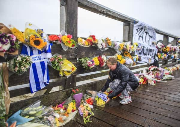 Floral tributes to the victims of the Shoreham Airshow crash placed on the Shoreham Tollbridge 250815FLORAL