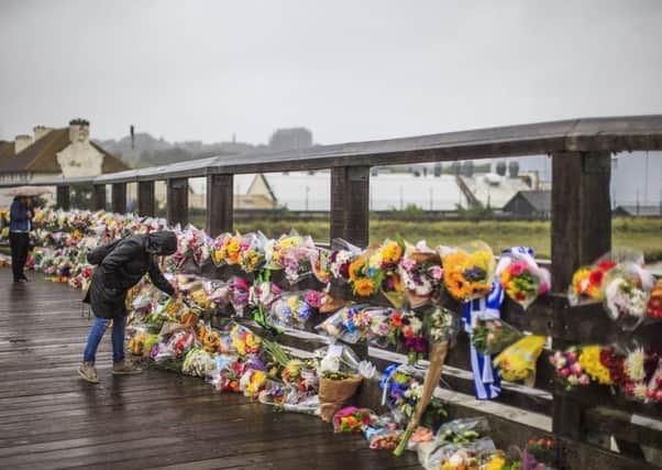 The number of floral tributes being left on the Old Toll Bridge is also growing