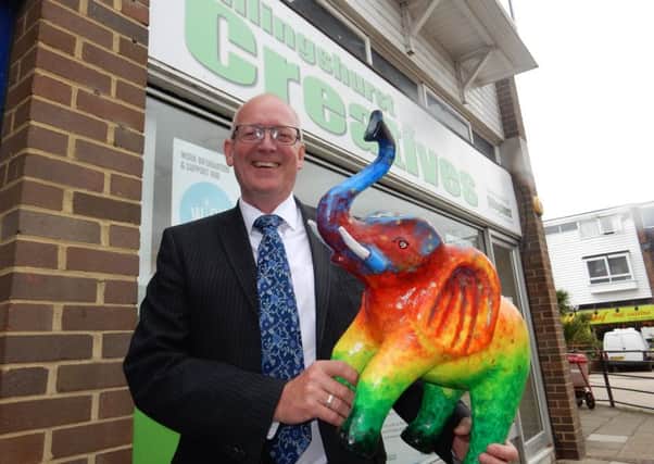 Adrian Passingham, branch manager of Henry Adams and Billingshurst Chamber of Commerce member, with his companys elephant at the Billingshurst Creatives shop in Jengers Mead.