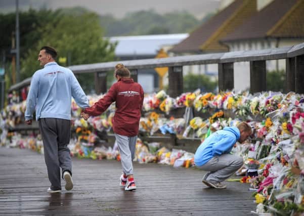 Floral tributes to the victims of the Shoreham Airshow crash placed on the Old Toll Bridge, Shoreham 250815FLORAL