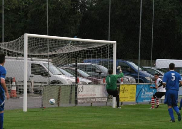 Horsham YMCAs Dan Sullivan nets the first of his three goals against East Preston