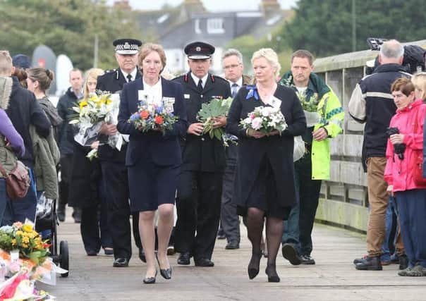 Emergency services and public figures, including Sussex Police Chief Constable Giles York lay flowers on the Old Toll Bridge, in Shoreham. Picture by Eddie Mitchell