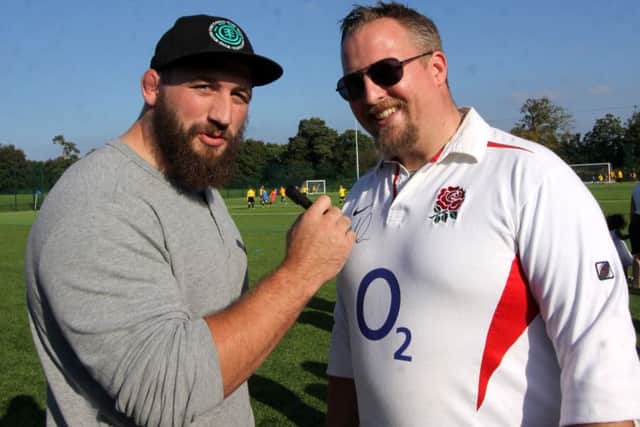 Joe Marler of England, and Harlequins captain sings his autograph on a fans England shirt. Picture by Ron Hill SUS-140509-124113001