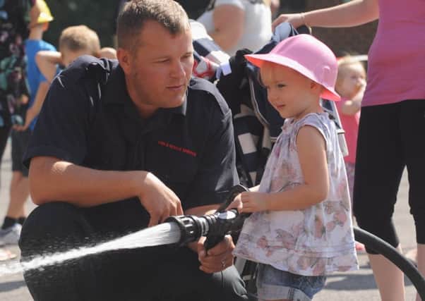 Nicole Lawson,3, has a go with the waterhhose at last year's open day PICTURE BY LOUISE ADAMS