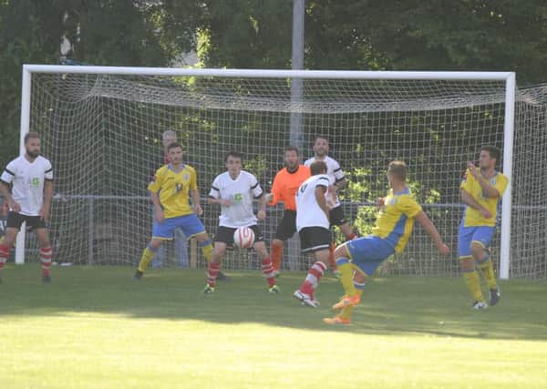 Burgess Hill place YM defence under pressure. Photo by Clive Turner