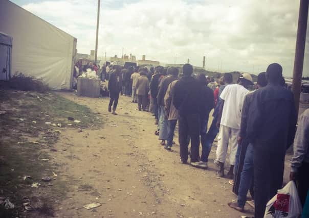 Refugees queue for supplies in 'The Jungle' refugee camp, Calais. Picture courtesy of Amanda Baker, founder of Blueprint 22 youth organisation SUS-150709-124148001