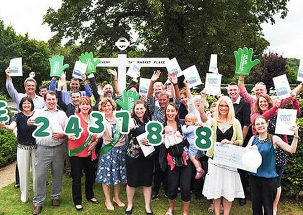 Fundraisers from MacMillan and staff at Hall & Woodhouse celebrate £240,000 raised for the charity