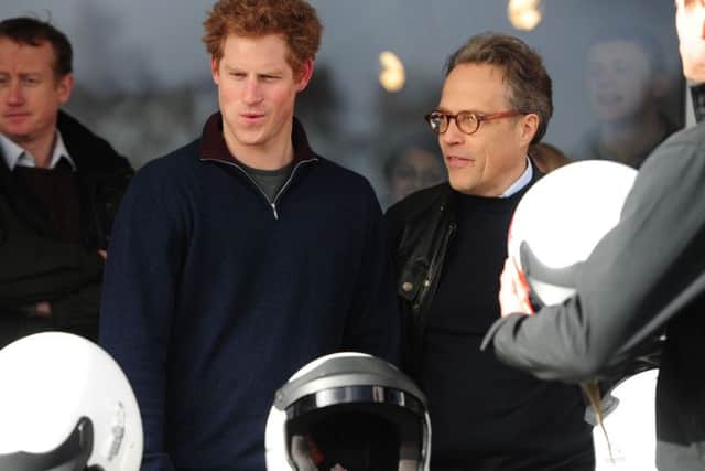 Prince Harry sees a car which catches his eye, with Lord March at the race track.Picture by Kate Shemilt.