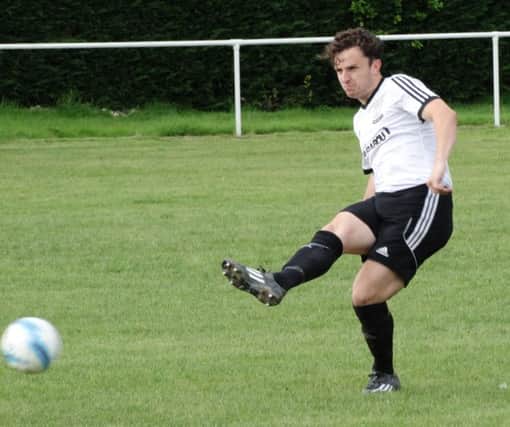 Josh Elliott-Noye plays a pass for Bexhill United against AFC Croydon Athletic. Picture courtesy Mark Killy