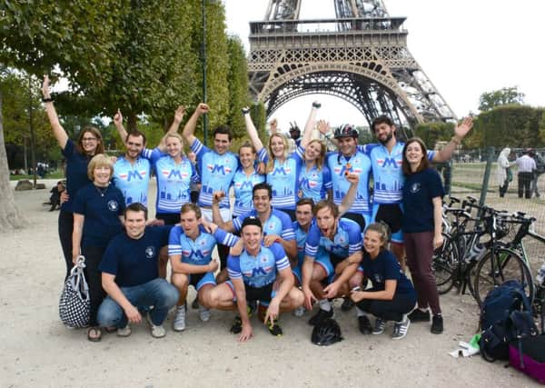 Ashington men Fred Jacobsen (back row, fourth from the left) and Henry Webster (crouching at the front second from left)  are  pictured near the Eiffel Tower in Paris with the rest of Team  Bike for Mike and their support team SUS-150909-123441001