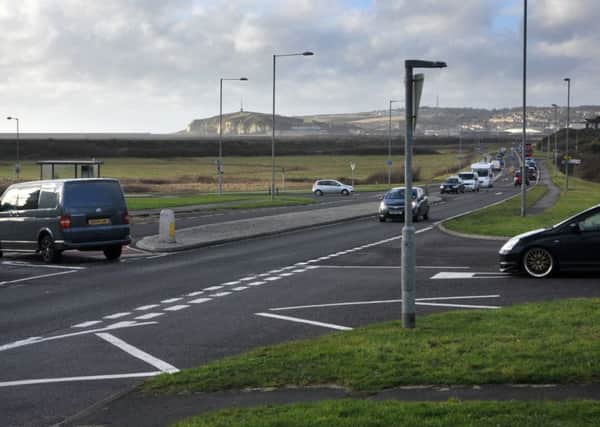 Traffic on the A259 Buckle By-Pass where it becomes Newhaven Road with Hill Rise and Marine Parade joining it and Bishopstone Road in the distance also joining.