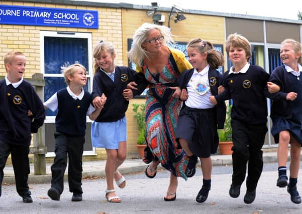 Headteacher at Aldingbourne Primary, Elizabeth Webster, celebrating with pupils. ks1500459-2
