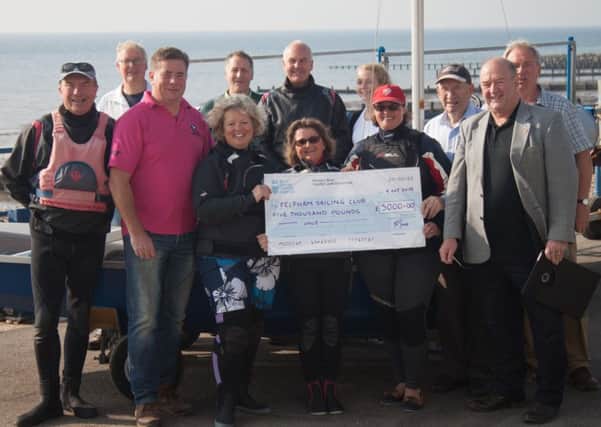 Cllr Graham Jones, county councillor for Felpham, handing over the cheque to club members