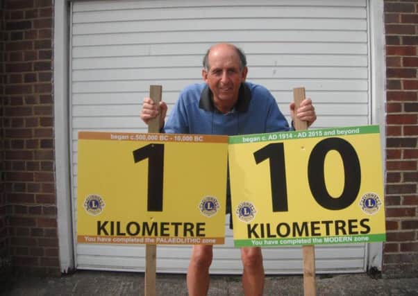 Bexhill-Hastings Link Road 10K race director Eric Hardwick with the 1 kilometre and 10 kilometre marker signs SUS-150829-114310002