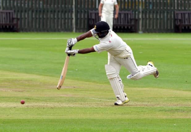 Ashar Zaidi leans into a shot during his unbeaten century for Bexhill against Eastbourne. Picture courtesy Peter Cripps (SUS-150709-000525008)