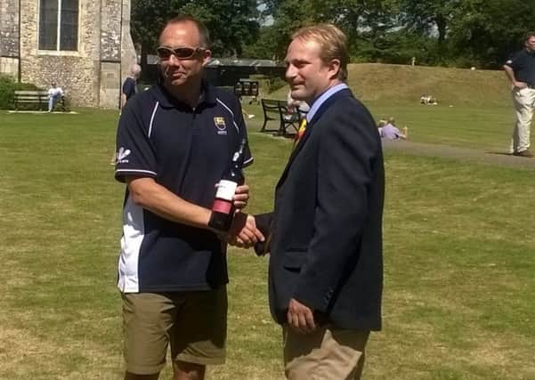 John Edwards is presented with a gift by the MCC at Oaklands Park