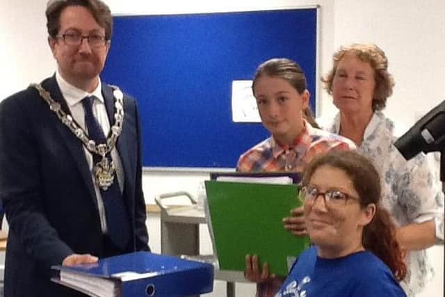 Residents submit a 6,800 signature petition over the future of Littlehampton's Swimming and Sports Centre to Arun District Council SUS-150914-113052001