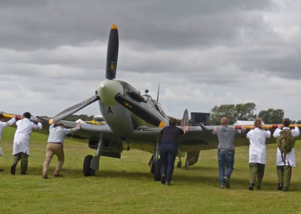 Twelve to move a Spitfire Goodwood Revival. Picture by Richard Cooke