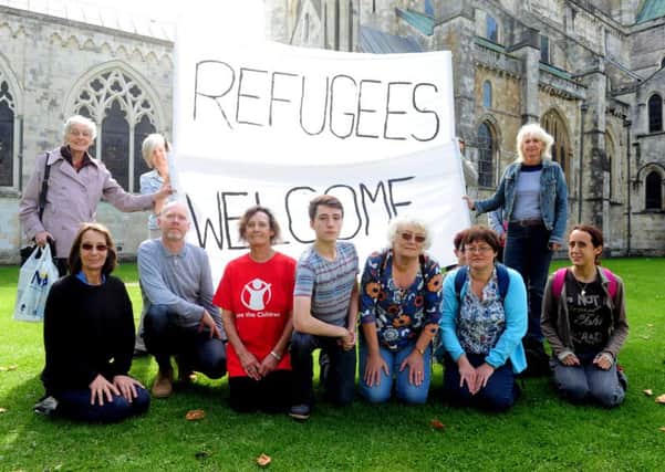 ks1500440-2 Campaigners at Chichester Cathedral show their support for refugees attempting to come to the UK