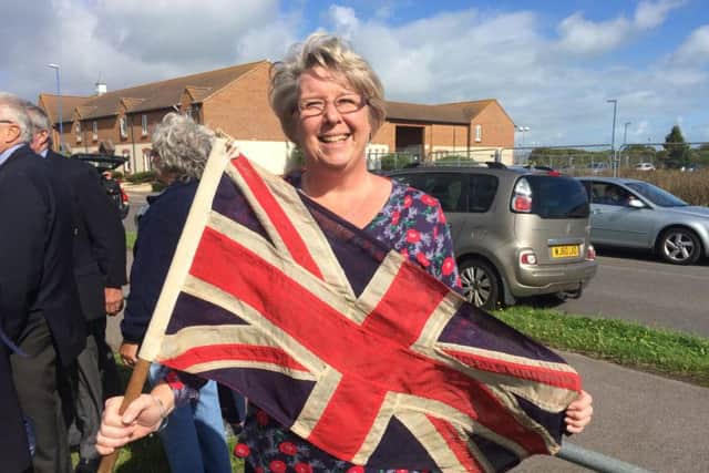 Louise Ansell with a Union Flag from 1941 which belonged to her mother