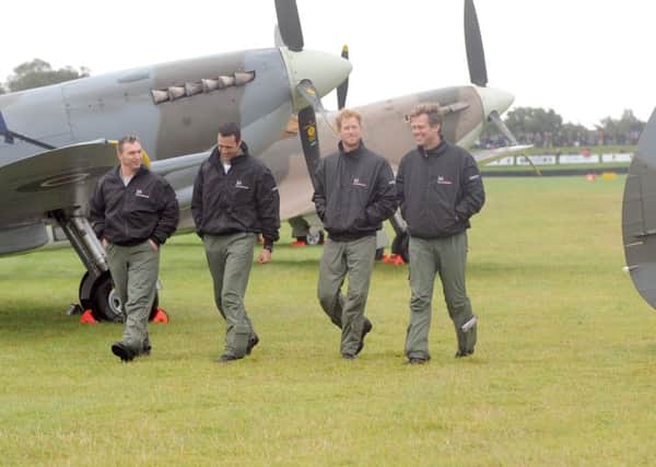 HRH Prince Harry took part in the Battle of Britain Flypast at Goodwood Aerodrome. 

Pictured is: (l-r) Alan Robinson, Nathan Forster, HRH Prince Harry and Matt Jones. 

Picture: Sarah Standing (151575-5530)