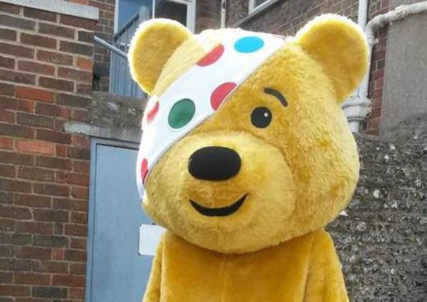 Katherine Gould dressed up as Pudsey Bear in Steyning high street to help raise funds for her boyfriend William Garrett's fundraiser SUS-150916-121133001