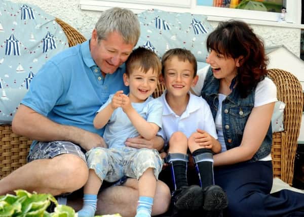 Toby Booker with his parents, Ian and Jess, and younger brother Harry ks1500076-2