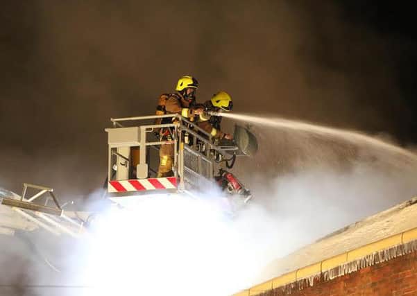 Firefighters utilise the aerial ladder platform to tackle blaze in a Bognor furniture shop   Picture: Eddie Mitchell